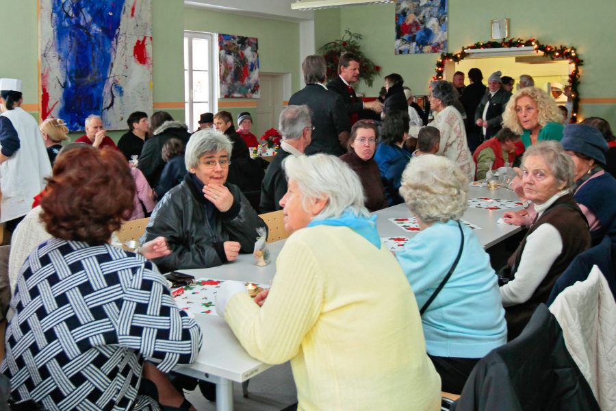 Women sitting around a table, eating and discussing.